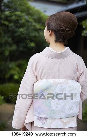 Young Japanese woman wearing traditional kimono View Large Photo Image Stock Photo - Young Japanese woman wearing traditional kimono. Fotosearch