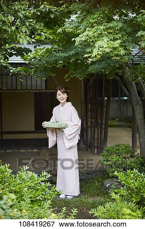 Stock Photo - Young Japanese woman wearing traditional kimono. Fotosearch