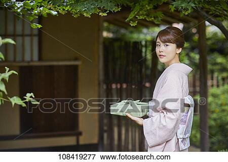 Young Japanese woman wearing traditional kimono View Large Photo Image Stock Photo - Young Japanese woman wearing traditional kimono. Fotosearch