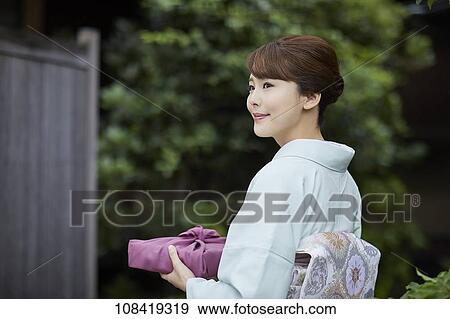 Young Japanese woman wearing traditional kimono View Large Photo Image Stock Photo - Young Japanese woman wearing traditional kimono. Fotosearch