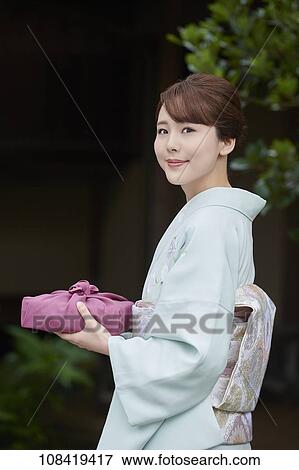 Young Japanese woman wearing traditional kimono View Large Photo Image Stock Photo - Young Japanese woman wearing traditional kimono. Fotosearch