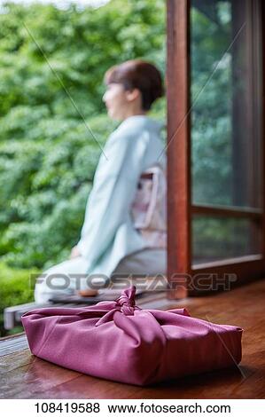 Young Japanese woman wearing traditional kimono View Large Photo Image Stock Photo - Young Japanese woman wearing traditional kimono. Fotosearch