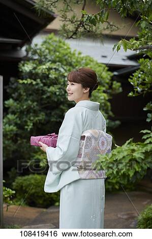 Young Japanese woman wearing traditional kimono View Large Photo Image Stock Photograph - Young Japanese woman wearing traditional kimono. Fotosearch