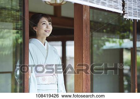 Young Japanese woman wearing traditional kimono View Large Photo Image Stock Photograph - Young Japanese woman wearing traditional kimono. Fotosearch