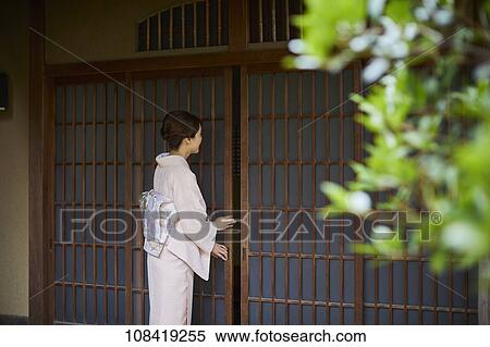 Young Japanese woman wearing traditional kimono View Large Photo Image Stock Photography - Young Japanese woman wearing traditional kimono. Fotosearch