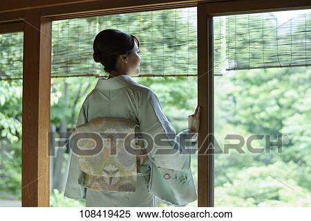 Young Japanese woman wearing traditional kimono View Large Photo Image Stock Photography - Young Japanese woman wearing traditional kimono. Fotosearch