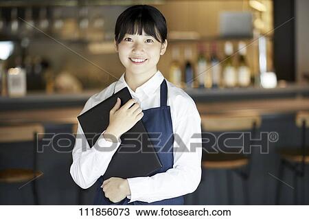 Young Japanese woman working at a restaurant View Large Photo Image Stock Image - Young Japanese woman working at a restaurant. Fotosearch