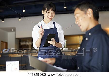 Young Japanese woman working at a restaurant View Large Photo Image Stock Image - Young Japanese woman working at a restaurant. Fotosearch