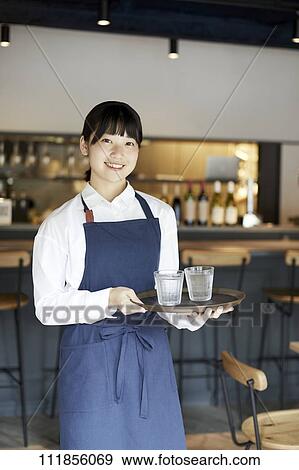 Young Japanese woman working at a restaurant View Large Photo Image Stock Photo - Young Japanese woman working at a restaurant. Fotosearch