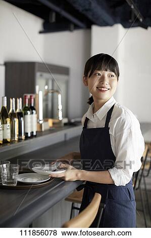 Young Japanese woman working at a restaurant View Large Photo Image Stock Photo - Young Japanese woman working at a restaurant. Fotosearch