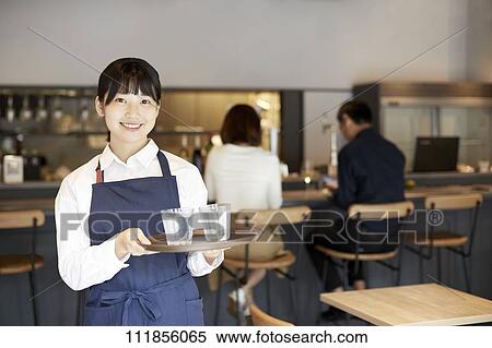 Young Japanese woman working at a restaurant View Large Photo Image Stock Photography - Young Japanese woman working at a restaurant. Fotosearch
