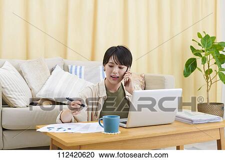 Young Japanese woman working at home View Large Photo Image Stock Image - Young Japanese woman working at home. Fotosearch