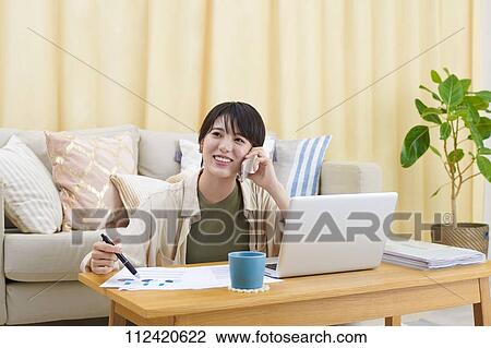 Young Japanese woman working at home View Large Photo Image Stock Image - Young Japanese woman working at home. Fotosearch