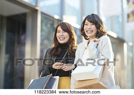 Picture - Young Japanese women downtown Tokyo. Fotosearch