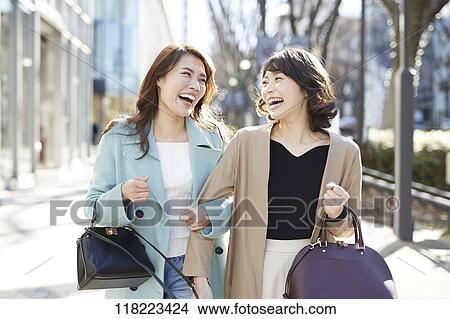 Picture - Young Japanese women downtown Tokyo. Fotosearch