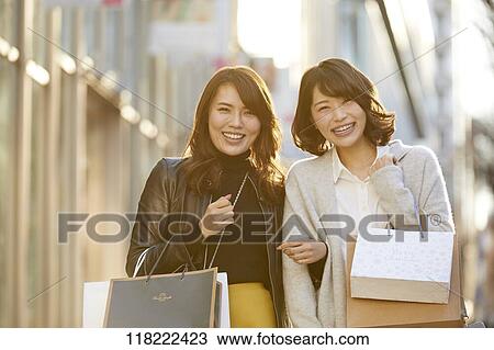 Stock Image - Young Japanese women downtown Tokyo. Fotosearch