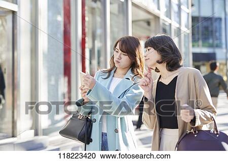 Stock Image - Young Japanese women downtown Tokyo. Fotosearch