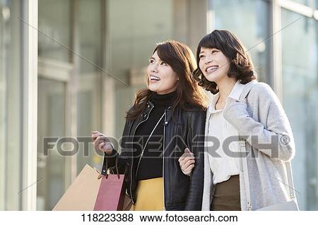 Stock Photo - Young Japanese women downtown Tokyo. Fotosearch