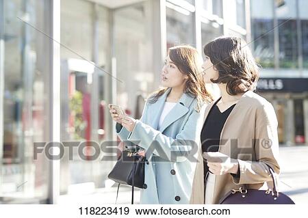 Stock Photo - Young Japanese women downtown Tokyo. Fotosearch