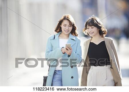 Stock Photograph - Young Japanese women downtown Tokyo. Fotosearch
