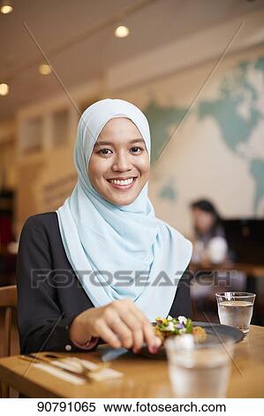 Young South-east Asian woman eating at restaurant View Large Photo Image Stock Photography - Young South-east Asian woman eating at restaurant. Fotosearch