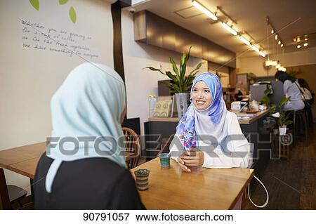 Young South-east Asian women eating at restaurant View Large Photo Image Stock Photo - Young South-east Asian women eating at restaurant. Fotosearch