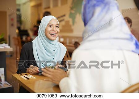 Young South-east Asian women eating at restaurant View Large Photo Image Stock Photo - Young South-east Asian women eating at restaurant. Fotosearch