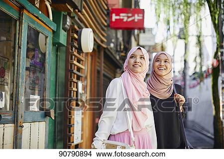 Young South-east Asian women enjoying sightseeing in Tokyo View Large Photo Image Picture - Young South-east Asian women enjoying sightseeing in Tokyo. Fotosearch