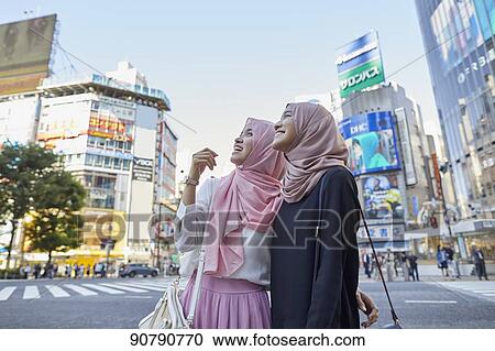 Young South-east Asian women enjoying sightseeing in Tokyo View Large Photo Image Stock Image - Young South-east Asian women enjoying sightseeing in Tokyo. Fotosearch