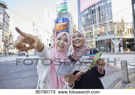 Young South-east Asian women enjoying sightseeing in Tokyo View Large Photo Image Stock Image - Young South-east Asian women enjoying sightseeing in Tokyo. Fotosearch
