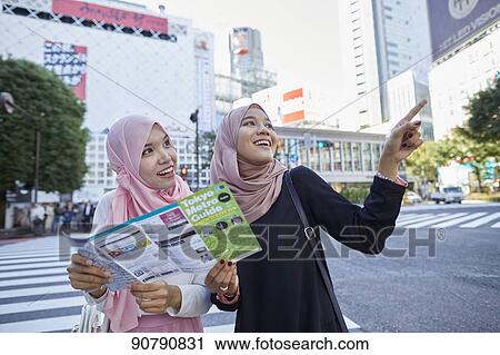 Young South-east Asian women enjoying sightseeing in Tokyo View Large Photo Image Stock Image - Young South-east Asian women enjoying sightseeing in Tokyo. Fotosearch