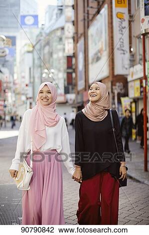 Young South-east Asian women enjoying sightseeing in Tokyo View Large Photo Image Stock Image - Young South-east Asian women enjoying sightseeing in Tokyo. Fotosearch