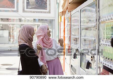 Stock Image - Young South-east Asian women enjoying sightseeing in Tokyo. Fotosearch