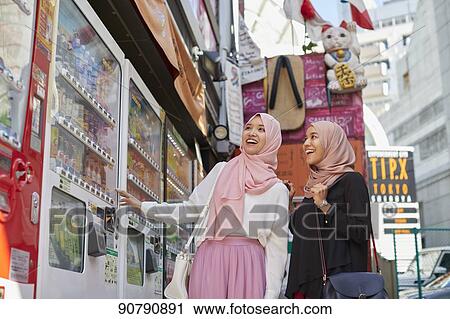 Young South-east Asian women enjoying sightseeing in Tokyo View Large Photo Image Stock Image - Young South-east Asian women enjoying sightseeing in Tokyo. Fotosearch