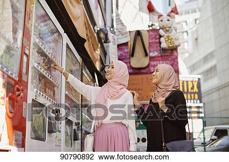 Young South-east Asian women enjoying sightseeing in Tokyo View Large Photo Image Stock Image - Young South-east Asian women enjoying sightseeing in Tokyo. Fotosearch