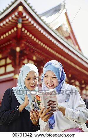 Young South-east Asian women enjoying sightseeing in Tokyo View Large Photo Image Stock Image - Young South-east Asian women enjoying sightseeing in Tokyo. Fotosearch
