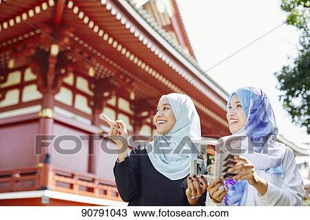 Young South-east Asian women enjoying sightseeing in Tokyo View Large Photo Image Stock Image - Young South-east Asian women enjoying sightseeing in Tokyo. Fotosearch