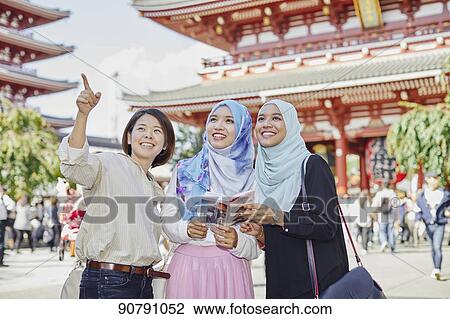 Young South-east Asian women enjoying sightseeing in Tokyo View Large Photo Image Stock Image - Young South-east Asian women enjoying sightseeing in Tokyo. Fotosearch