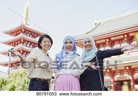 Young South-east Asian women enjoying sightseeing in Tokyo View Large Photo Image Stock Image - Young South-east Asian women enjoying sightseeing in Tokyo. Fotosearch