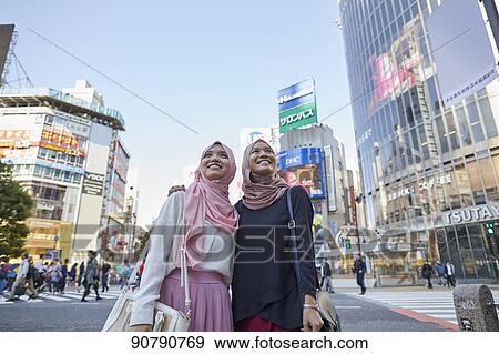 Young South-east Asian women enjoying sightseeing in Tokyo View Large Photo Image Stock Photo - Young South-east Asian women enjoying sightseeing in Tokyo. Fotosearch