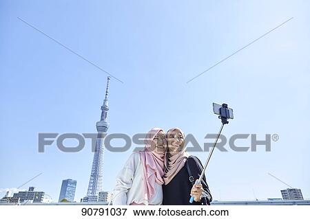 Young South-east Asian women enjoying sightseeing in Tokyo View Large Photo Image Stock Photo - Young South-east Asian women enjoying sightseeing in Tokyo. Fotosearch