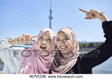 Young South-east Asian women enjoying sightseeing in Tokyo View Large Photo Image Stock Photo - Young South-east Asian women enjoying sightseeing in Tokyo. Fotosearch