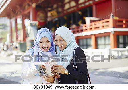 Young South-east Asian women enjoying sightseeing in Tokyo View Large Photo Image Stock Photo - Young South-east Asian women enjoying sightseeing in Tokyo. Fotosearch
