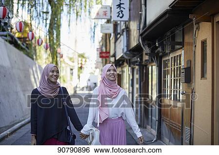 Young South-east Asian women enjoying sightseeing in Tokyo View Large Photo Image Stock Photograph - Young South-east Asian women enjoying sightseeing in Tokyo. Fotosearch