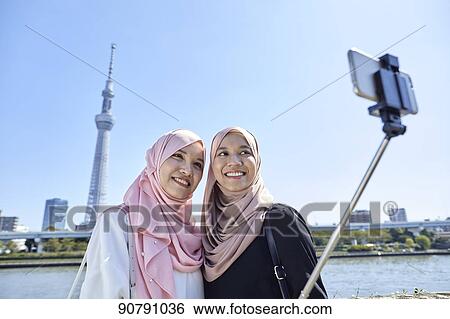 Young South-east Asian women enjoying sightseeing in Tokyo View Large Photo Image Stock Photograph - Young South-east Asian women enjoying sightseeing in Tokyo. Fotosearch