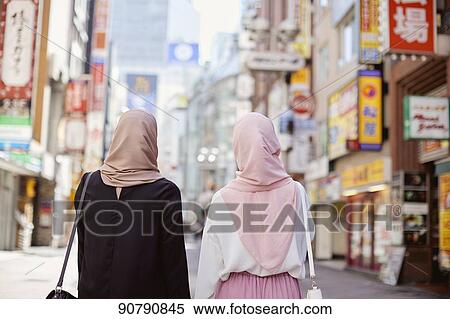 Stock Photography - Young South-east Asian women enjoying sightseeing in Tokyo. Fotosearch