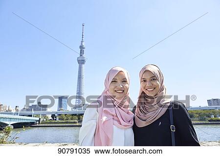 Stock Photography - Young South-east Asian women enjoying sightseeing in Tokyo. Fotosearch