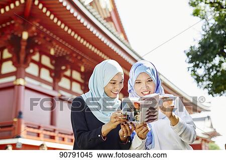 Young South-east Asian women enjoying sightseeing in Tokyo View Large Photo Image Stock Photography - Young South-east Asian women enjoying sightseeing in Tokyo. Fotosearch