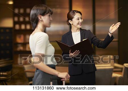 Young woman checking in at hotel View Large Photo Image Stock Image - Young woman checking in at hotel. Fotosearch