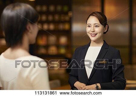 Young woman checking in at hotel View Large Photo Image Stock Image - Young woman checking in at hotel. Fotosearch